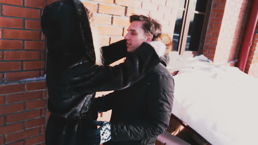 Girl dresses a guy hood on her head and hugs