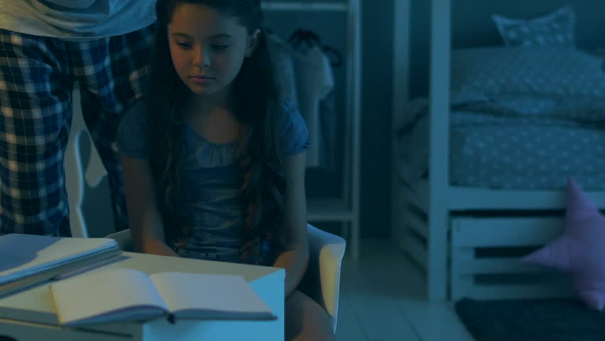 Cheerless sad little girl being punished by her father
