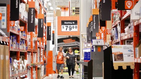 Port Coquitlam, BC, Canada - September 07, 2017 : Motion of customer and clerk walking to faucet and sink repair products corridor in Home Depot store with 4k resolution