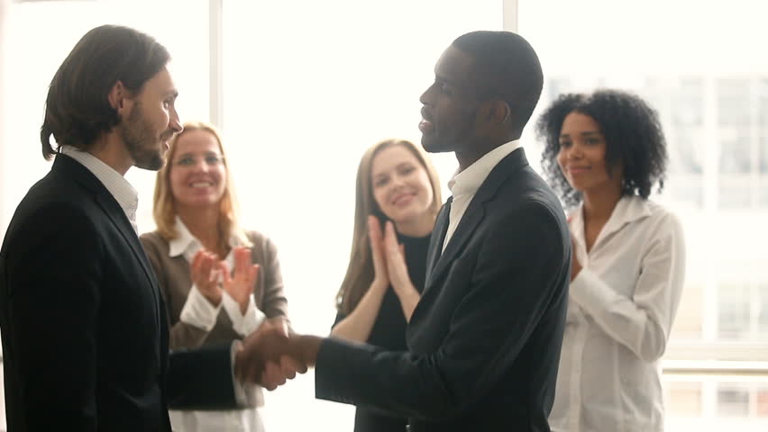 Boss promoting rewarding african american male worker, appreciating for good job, businessmen wearing suit congratulating shaking hands with applauding staff standing in office, employee recognition Royalty-Free Stock Footage #30610945