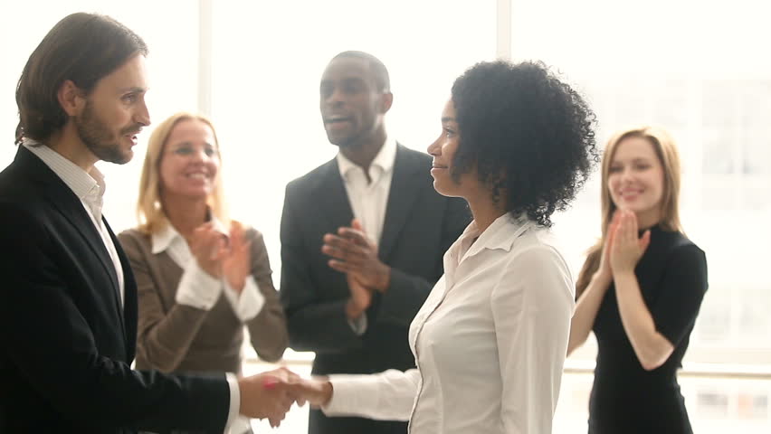 Company boss handshaking promoting african manager while colleagues applaud, businessman congratulates black woman with career achievement, shake hands rewarding for good work, employee of the month Royalty-Free Stock Footage #30610954