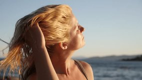 Woman makes hair on the beach slow-mo 1920X1080 HD footage - Slow motion relaxing of beautiful blond female 1080p FullHD video
