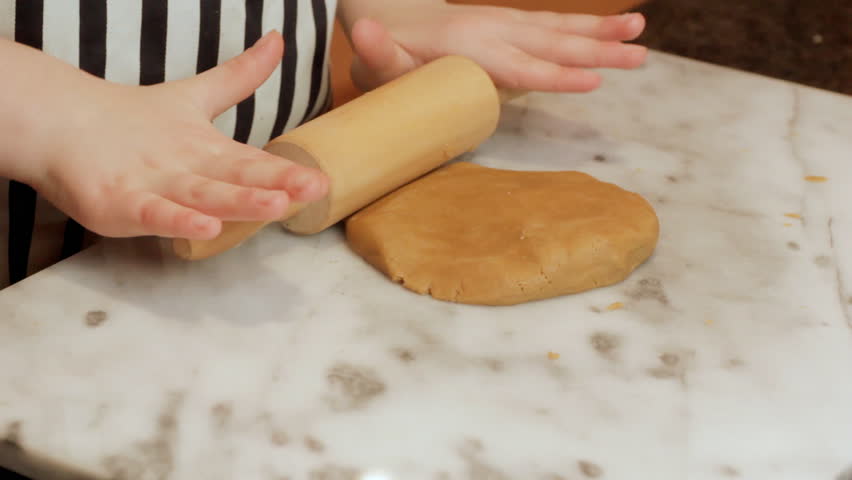 Little girl rolling cookie dough 1