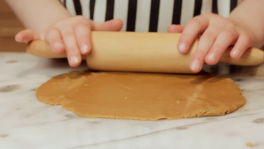 Little girl rolling cookie dough 2