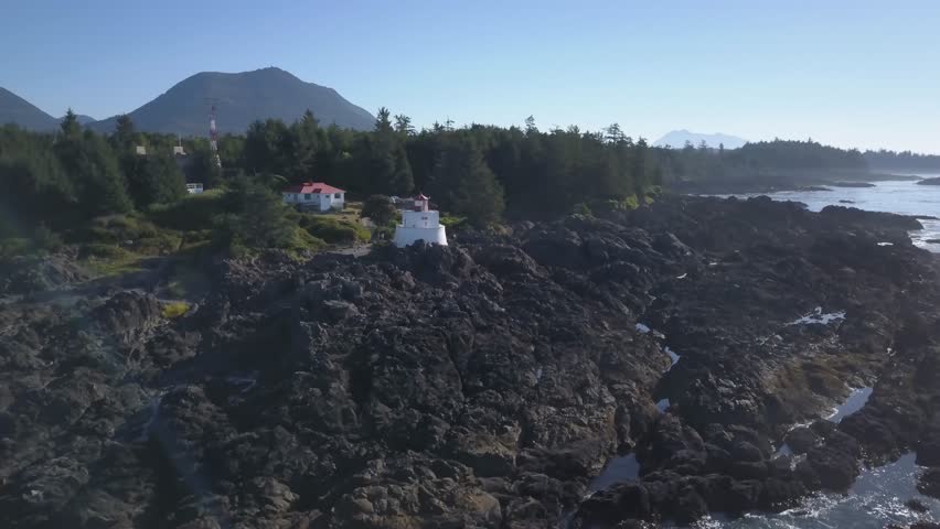 Aerial view of the lighthouse on the beautiful rocky coast on Pacific Ocean during a summer morning. Video taken in Ucluelet, Vancouver Island, British Columbia, Canada.