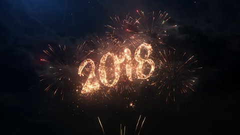 2018 Happy New Year greeting text with particles and sparks on black night sky with colored slow motion fireworks on background, beautiful typography magic design.