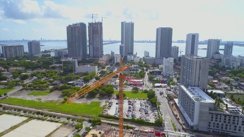 MIAMI, FL, USA - SEPTEMBER 5, 2017: Aerial footage construction cranes crossing over a development