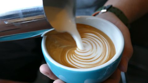 Barista making of cafe latte art, heart shape