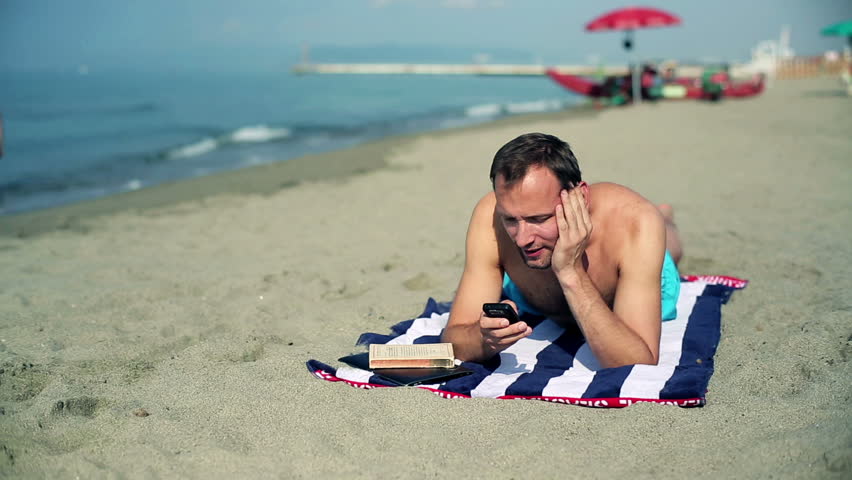 Happy couple with tablet computer and cellphone, outdoors
