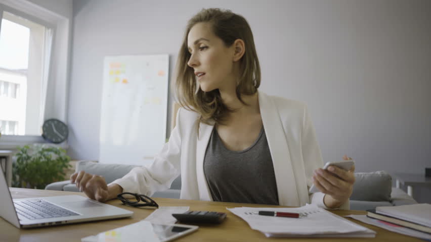 Young businesswoman working using laptop from home office | Shutterstock HD Video #30661411