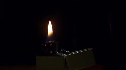 lighter zippo, a fire burns on a black background