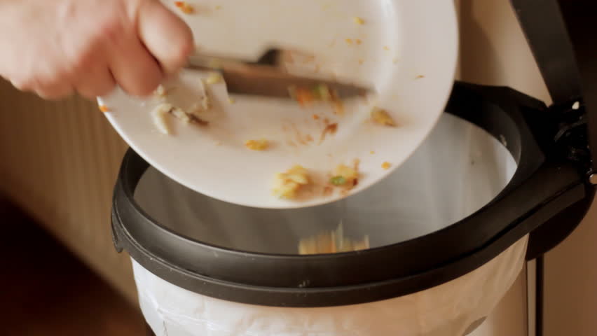 Scraping leftover meal into bin