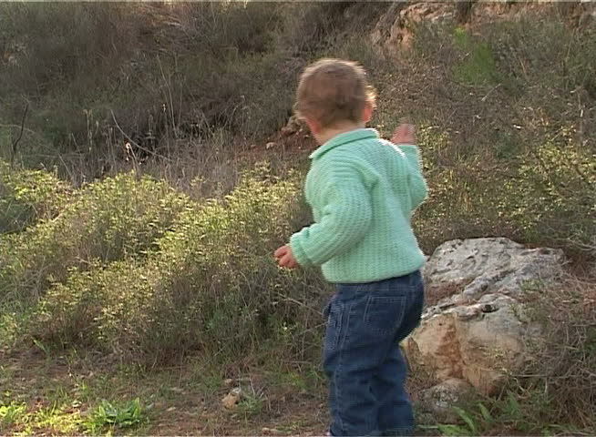 Little girl walking and playing on the forest