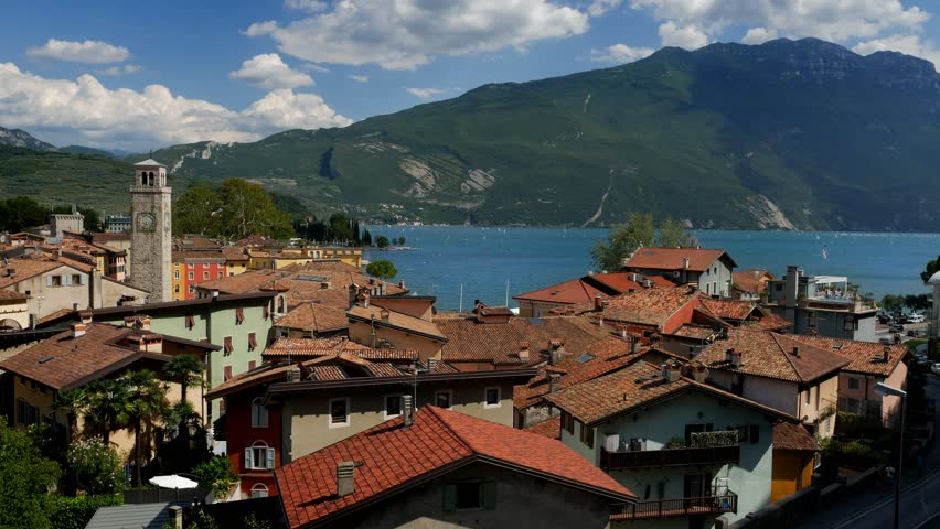View of Lake Garda and the roofs of Riva del Garda town on a sunny day in Italy