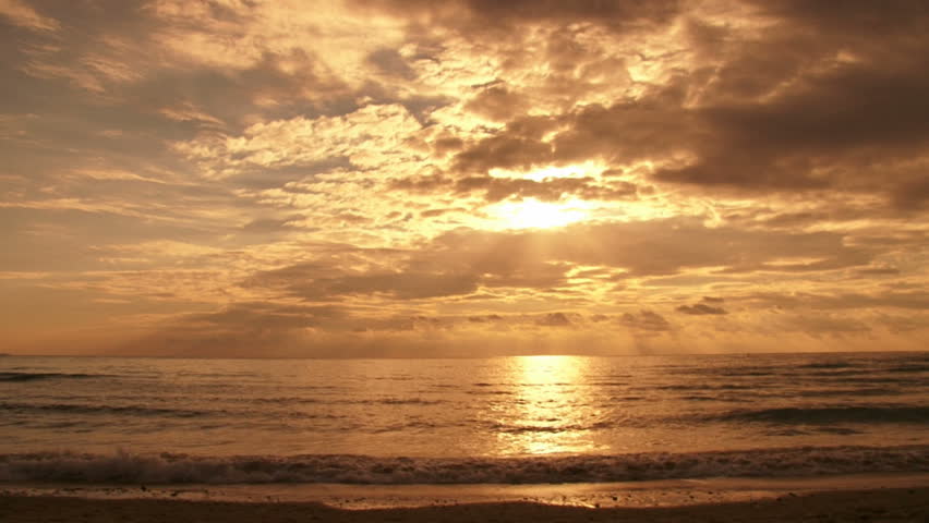 Sunset, guy walks & talks on the phone