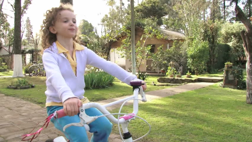 Girl riding a bicycle. Slow Motion