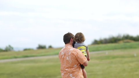 Father Holds His Little Boy, They Look Out At View, Enjoy Nature Together, Slow Motion