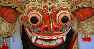 Traditional mask. colorfully painted in intricate detail. of a mythical barong creature. on display in Bali. Indonesia. Video 4k