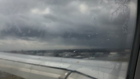 Rain drops view from airplane window ,Slow motion Handheld camera Balanced Steady shot 
