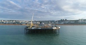 Aerial dolly view of the palace pier in Brighton, early morning