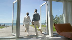 Happy Young Couple Holding Hands Runs out of Their Home onto the Terrace with the Seaside View. Shot on RED EPIC-W 8K Helium Cinema Camera. - Powered by Shutterstock - Get 15% off with code: PIKWIZARD15