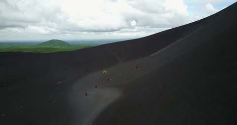 Cerro volcano in Nicaragua. People after sliding board on volcano aerial drone view