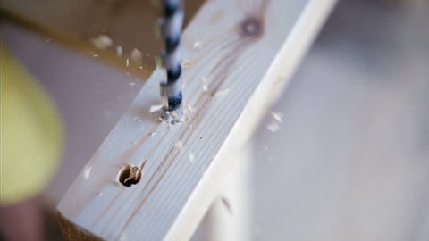 Nice CloseUp of Wood Drilling by a Craftsman with Electric Drill in the Workshop