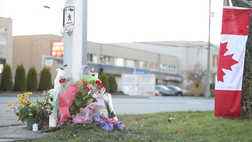 A roadside memorial marks the death of a young police officer killed in the line of duty.
