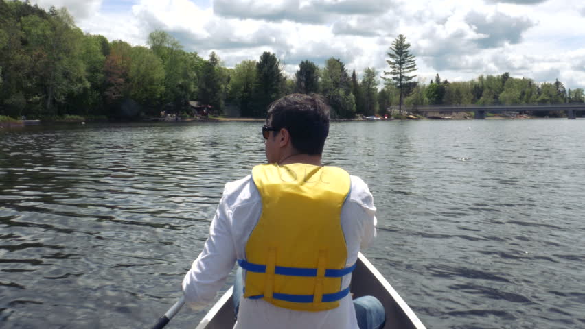 Man Rowing Around Cottage Country Ontario