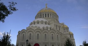 4K video footage view of beautiful Nikolskiy Navy cathedral, anchor square, area around it in the heart of Kronstadt town near St Petersburg 700 km from Moscow, Russia on sunny summer morning