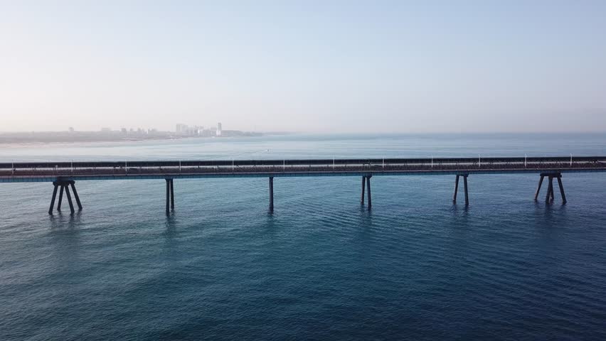 Power station pier on open blue water