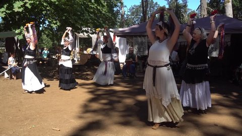 Silverton, Oregon - August 19, 2017: Female, woman dancers perform to drum beat music at Renaissance Fair.