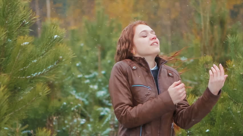 Ginger Woman Laughing Standing Under Snowfall