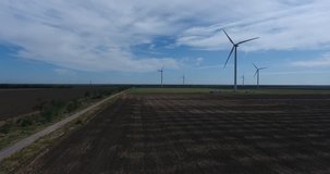 Aerial shot of Power Generating Windmills, wind turbines producing clean renewable energy