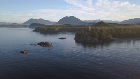 Aerial view of the beautiful natural seascape on Pacific Ocean Coast during a sunny summer sunrise. Video taken in Tofino, Vancouver Island, British Columbia, Canada.