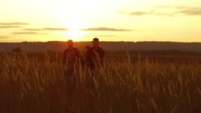 two tourists silhouettes. two tourists go nature at sunset. tourist silhouette nature slow motion video