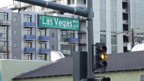 LAS VEGAS, NV / USA - September 10, 2017: Panning by a South Las Vegas Blvd street sign seen above a traffic control signal light at the 600 block of South Las Vegas Boulevard.