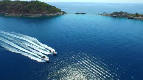 Power Boats Racing Past Islands at Sea