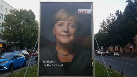GERMANY - CIRCA SEPTEMBER 2017 - Big CDU poster with picture of Merkel on traffic island, cars, street, Berlin