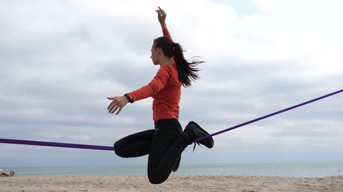 Young Sports Girl Balancing On A Slackline At Sea Shore Sand Beach Healthy Body Lifestyle