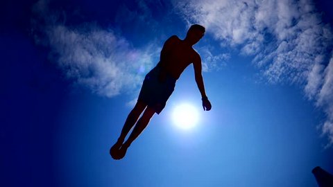 Young Guy Dark Silhouette Jumping On The Trampoline On Sky Sun Background Slow Motion Sport Activity