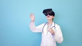 smiling young female doctor wearing VR technology device standing in blue background and viewing 3D video using hands touching simulation screen.