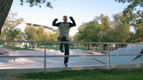 Young man doing parkour tricks in extreme sports park