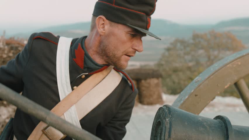 French soldier prepares a military cannon for battle