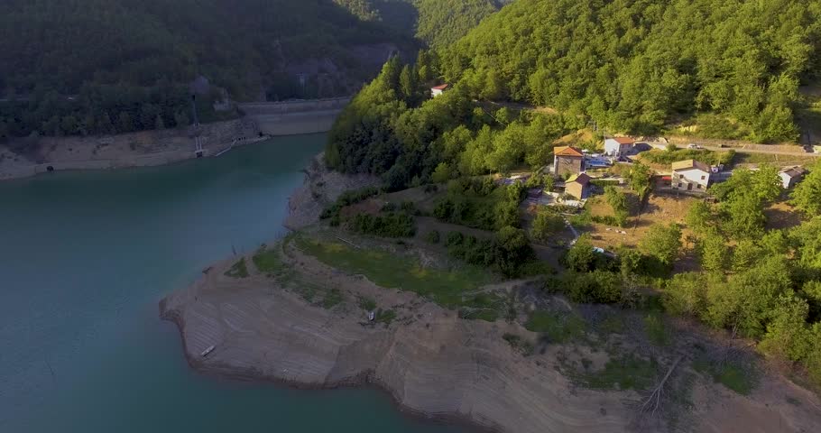 Aerial, beautiful lake with a dam barrier among the hills