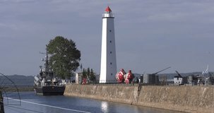 4K video footage view of Kronstadt town center and navy base, channels, boats, submarines, lighthouse and area around it near St Petersburg 700 km from Moscow, Russia on sunny summer morning