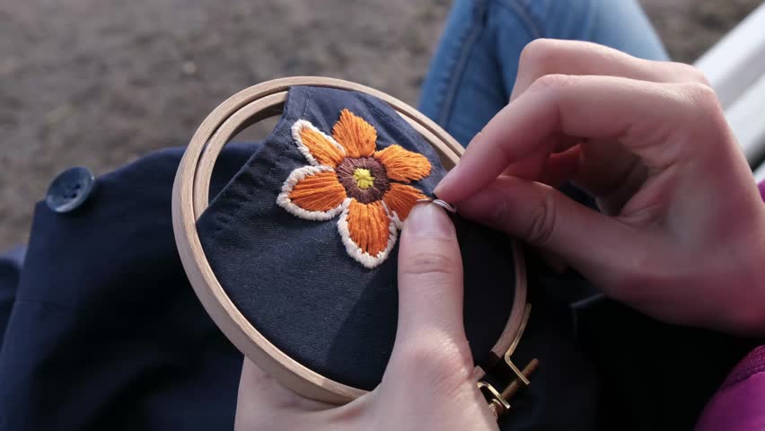 Girl embroidering close-up in park Royalty-Free Stock Footage #30754786