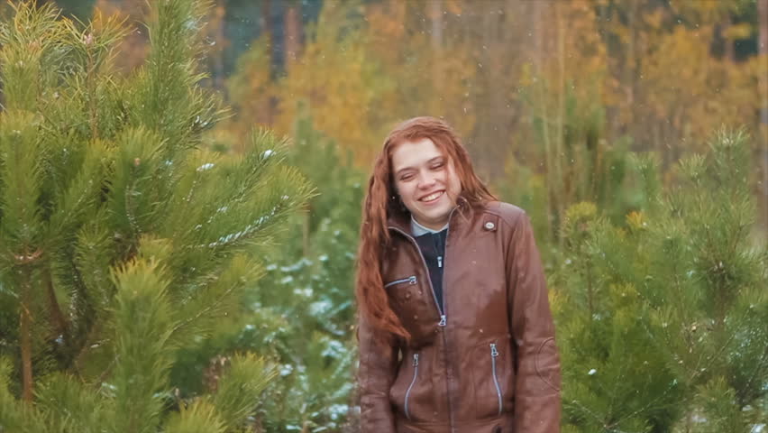 Ginger Woman Laughing Standing Under Snowfall
