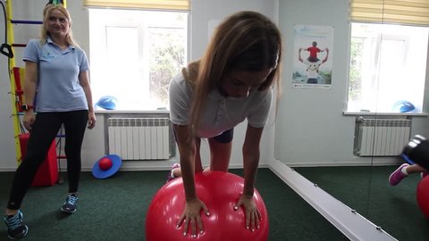 VINNITSA, UKRAINE, AUGUST 15, 2017: Physiotherapy: Beautiful, sexy girl in the gym. Exercise under supervision of physiotherapist. 