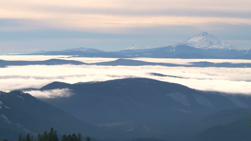 Time lapse of Mount Jefferson, Oregon with low clouds moving through forest.